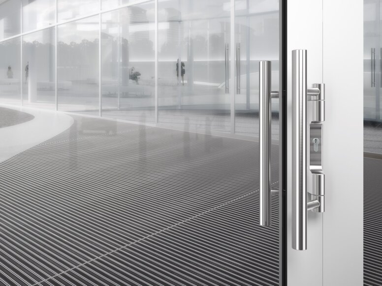 HEWI lever handle stainless steel matt Lever handle in matt polished stainless steel and "DRÜCKEN" signage on glass door with white frame