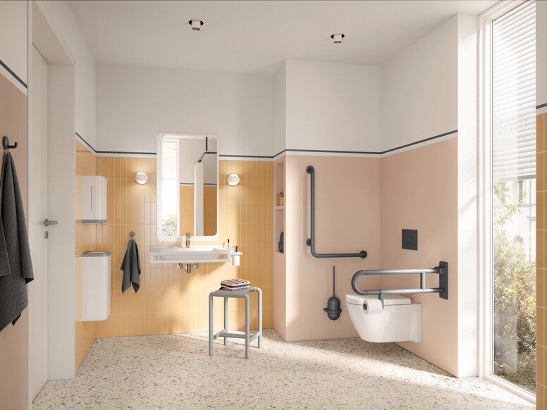 Wall-hung WC with a hinged support rail on the side and an L-shaped support rail, alongside a washbasin with a mirror and a stool