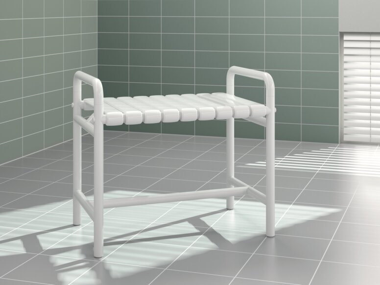 A bench with two white synthetic material armrests against a light green tiled wall