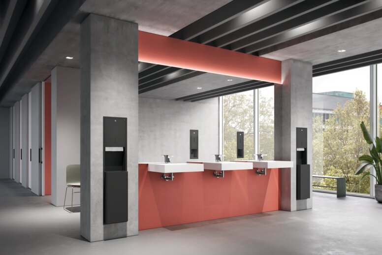 HEWI System 900 Concealed Fitting Three washbasins in the public area, set against grey-and-red concrete walls, with paper and soap dispensers recessed into the wall