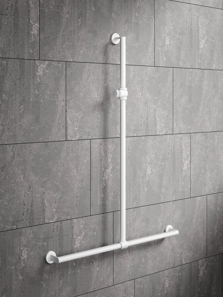 White powder-coated shower handrail with height adjustment and a horizontal support rail in front of grey stone tiles