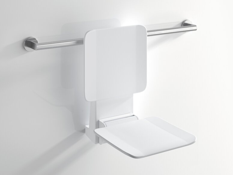 White hanging seat with a backrest and folded-down seating surface, attached to a horizontal stainless steel support rail against a white wall