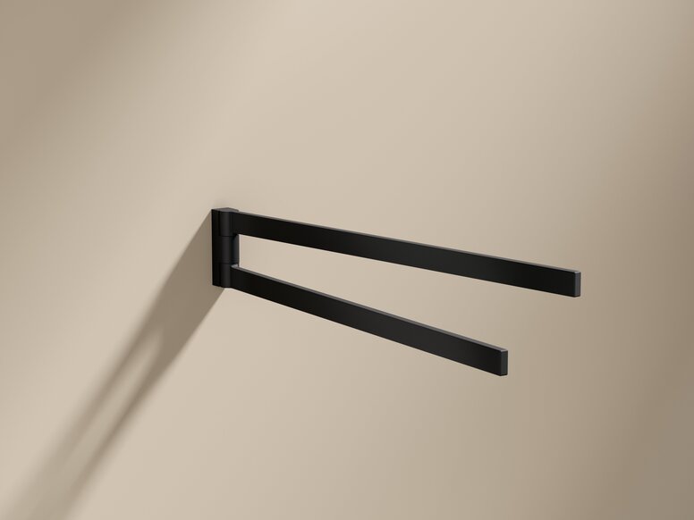 Black powder-coated towel holder with two arms on a beige wall