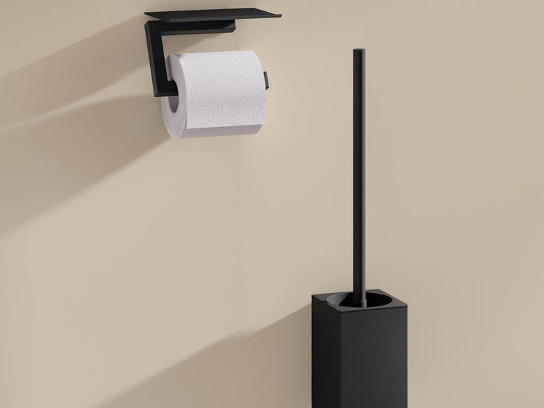 Black powder-coated toilet roll holder with a shelf and a black toilet brush with a holder on a beige wall