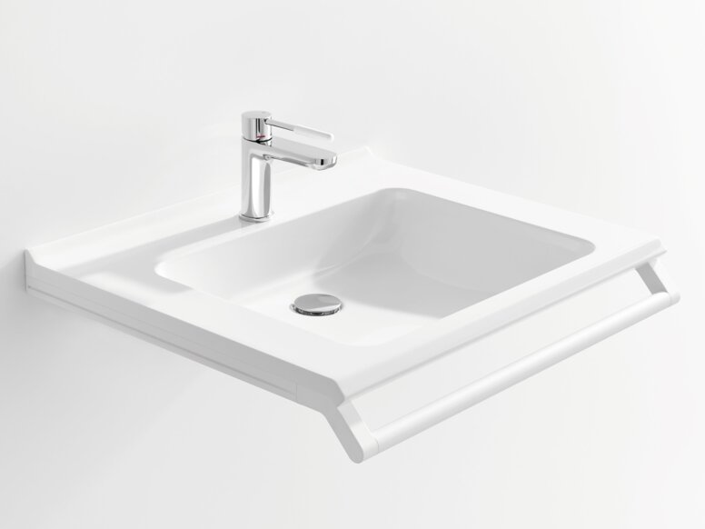 Weißer Waschtisch mit einer rechteckigen Beckenmulde, einem verchromtem Wasserhahn und einem Haltegriff an der Vorderkante