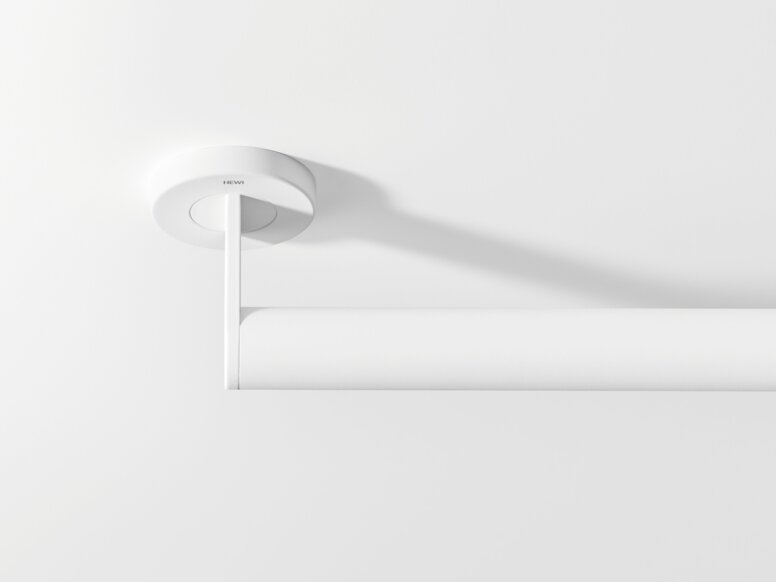 White support rail with a tubular grip and round wall mounting against a white background, viewed from above