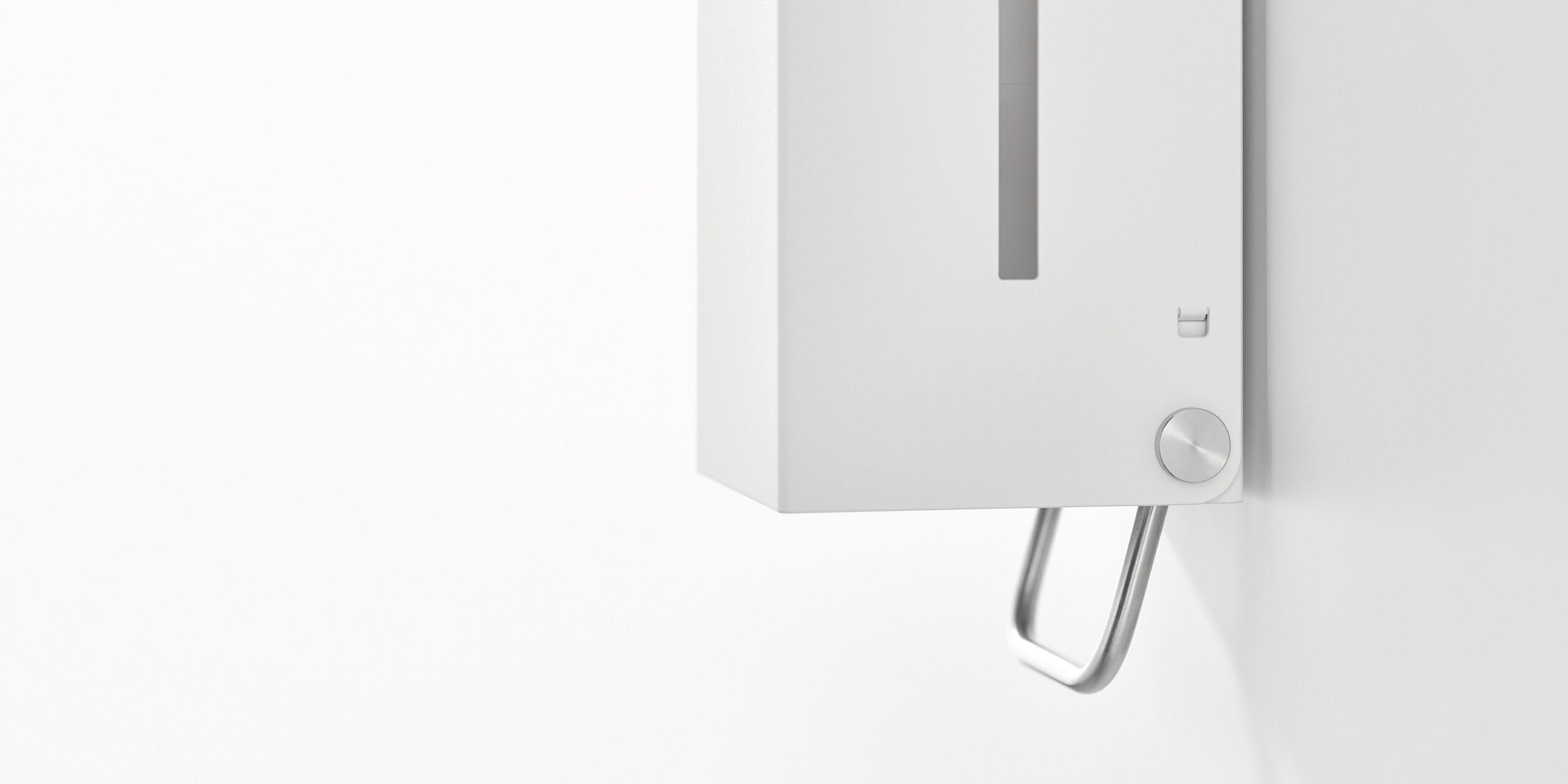 White wall-mounted soap dispenser with a viewing window and an operating lever on the underside against a white background