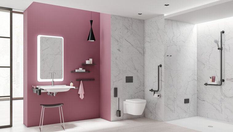 Modern bathroom with a pink wall behind the washbasin, illuminated mirror, wall-hung toilet and level-access shower with white and grey marble-effect tiles, complemented by black grab rails and fittings
