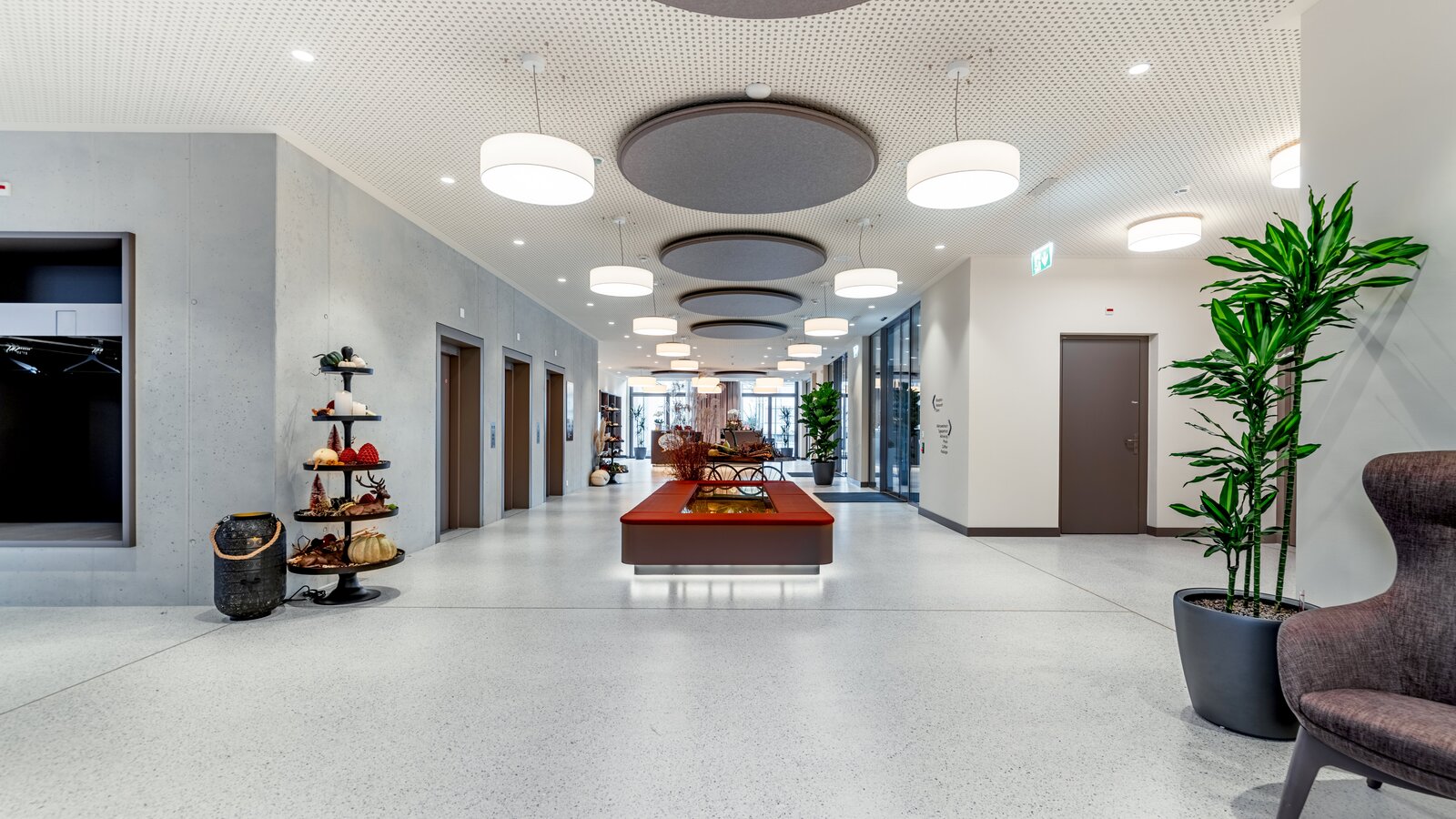 Foyer at Haslibrunnen in Switzerland Upholstered bench with an integrated plant display area in the foyer