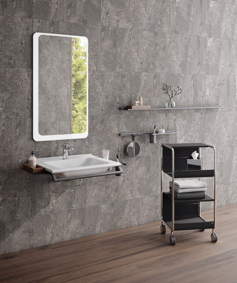 HEWI washbasin and side trolley Modular washbasin with grab rail and shelves, side trolley next to it in the colour black matt